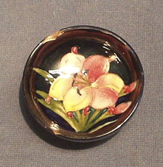 A circular Moorcroft African Lily patterned bowl, the base impressed Moorcroft England, with 2 chips, 3"