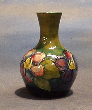 A Moorcroft club shaped Clematis patterned vase 5", the base impressed Moorcroft and with paper label "Potter to the Late Queen Mary"