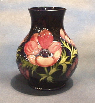 A Moorcroft anemone patterned vase with blue ground, impressed Moorcroft, Made in England and marked C34/94 10"