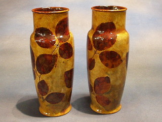 A pair of Art Nouveau cylindrical Royal Doulton vases decorated leaves, the bases impressed Royal Doulton X8531H 9004UEW 10"