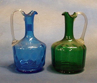 A 19th Century green  jug with clear glass handle and a blue glass ditto (cracked)