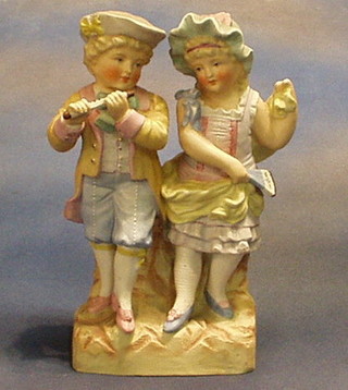 A 19th Century biscuit porcelain figure of a boy and girl, 11" (F and R)