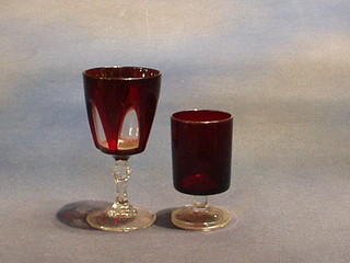 6 ruby glass wine glasses with clear glass stems and 3 red glass tumblers