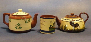 A Torquay Devonware pottery teapot with motto, 1 other and a preserve jar