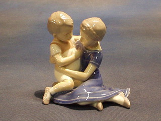 A Royal Copenhagen porcelain figure of a seated girl and boy, base marked B & G 1568 4"