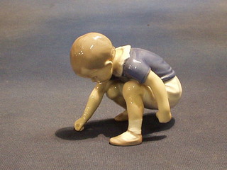 A Royal Copenhagen porcelain figure of a seated boy, the base marked B & G 1636, 3"