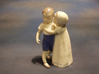 A Royal Copenhagen porcelain figure of a standing boy and girl, base marked B & G 1614, 7"