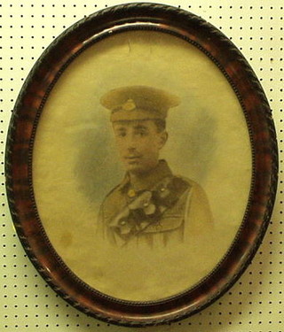 An enhanced coloured photograph "First World War Soldier" 19" oval