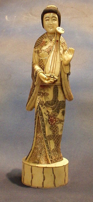 An ivory figure of a standing female musician 15"