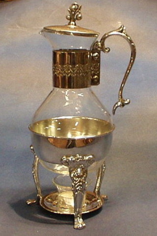 A glass and silver plated coffee jug with candle burner