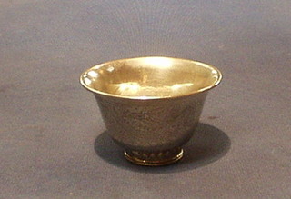 An oriental silver sake cup