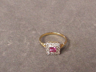 A lady's attractive gold ring set a square cut pink sapphire surrounded by 12 diamonds (approx 0.36 ct)
