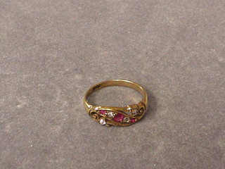 A lady's gold dress ring set 3 rubies and 4 diamonds