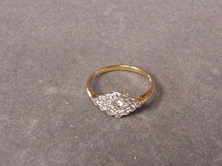 A lady's gold dress ring set a circular cut diamond surrounded by 12 small diamonds
