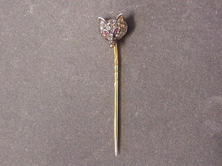 A stick pin in the form of  a foxes mask, set rubies and diamonds