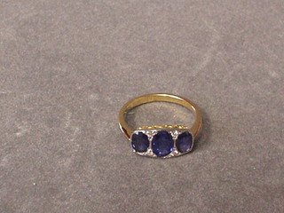 A lady's gold dress ring set 3 oval cut sapphires and 4 diamonds