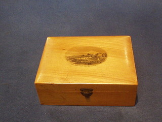 A wooden trinket box containing a collection of enamelled bowling brooches