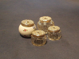 2 circular rouge pots with silver covers, a circular dressing table jar with silver cover and a porcelain ditto (4)