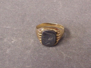 A 9ct gold signet ring set an intaglio cut panel