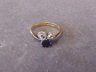 A lady's gold dress ring set 2 diamonds and a sapphire