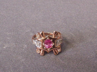 A 9ct gold dress ring set an oval cut pink coloured supported by 8 diamonds