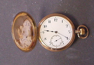 A gentleman's full hunter pocket watch with enamelled dial contained in a 9ct gold case