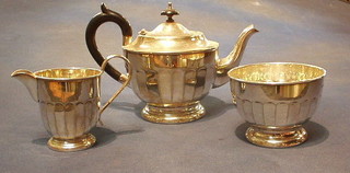 A circular silver plated 3 piece tea service