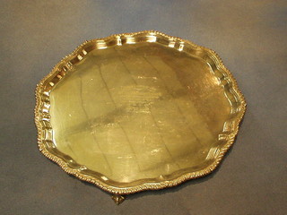 A silver plated bracketed salver raised on 3 ball and claw supports 14" inscribed