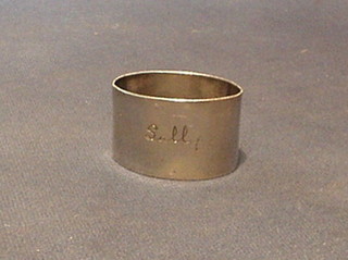 A silver napkin ring engraved "Sally"