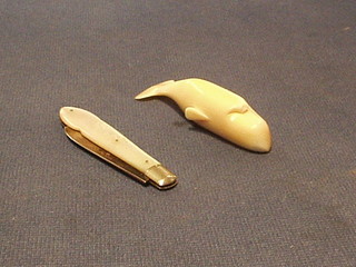 A carved ivory figure of a whale 3" and a folding fruit knife with silver blade and ivory grip