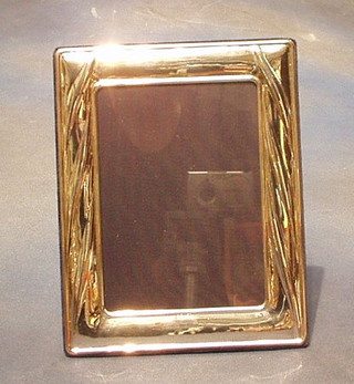 A modern plain silver photograph frame 10" x 7"