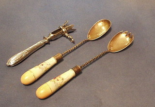 A silver plated ham bone clamp and a pair of silver plated salad servers with porcelain handles (3)