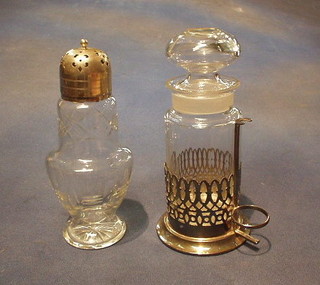 A cut glass pickle jar contained in a pierced silver plated stand and a cut glass sugar sifter with plated mounts