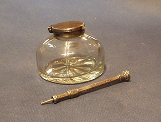 A circular glass inkwell with gun metal lid and a propelling pencil