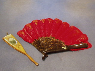 A tortoiseshell and red ostrich feather fan and an olive wood fan