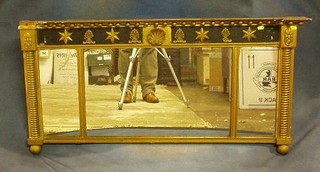 A Regency triple plate over mantel mirror contained in a gilt and black painted frame with ring turned columns to the side and with ball and shell decoration 47"