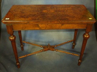 A fine quality late Victorian figured walnutwood D shaped card table, raised on turned and fluted supports with X framed stretcher 36"