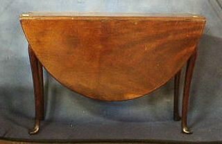 A Georgian mahogany oval drop flap gateleg dining table, raised on club supports 52"