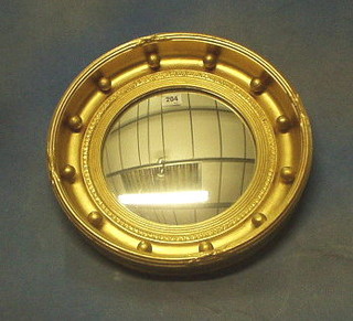 A circular convex wall mirror contained in a gilt ball studded frame 16"