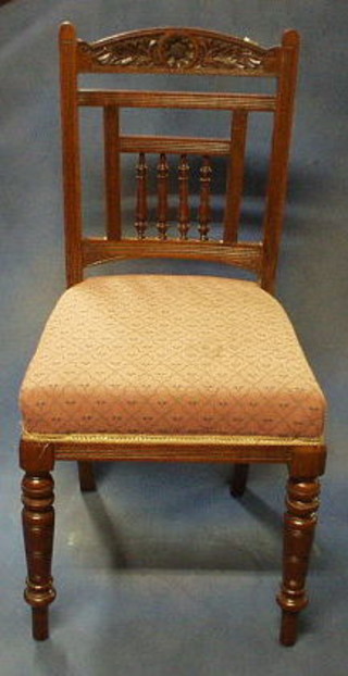 A set of 6 late Victorian carved walnutwood stick and rail back dining chairs with upholstered seats and bobbin turned decoration, on turned supports