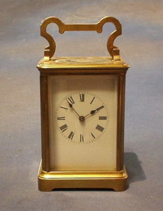 A French 19th Century 8 day striking carriage clock with enamelled dial, Roman numerals contained in a gilt metal case, 5"