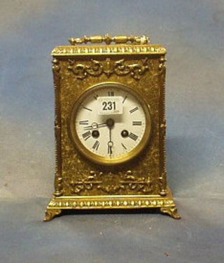 A 19th Century French 8 day striking mantel clock with enamelled dial and Roman numerals contained in a gilt metal case with carrying handle