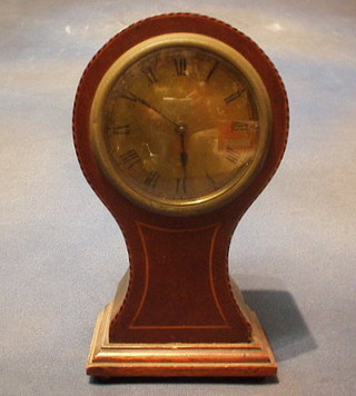 A 1930's 8 day bedroom timepiece contained in an inlaid mahogany balloon shaped case