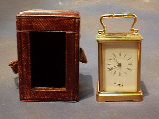 A French 19th Century 8 day striking carriage alarm clock with porcelain dial, striking on bell, contained in a gilt metal case 5", complete with leather travelling case