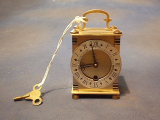 A reproduction 8 day mantel clock with silvered dial contained in a gilt metal case