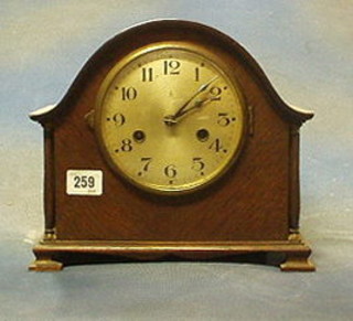 A 1930's striking mantel clock by Gustaav Becker with silvered dial contained in an oak arch shaped case