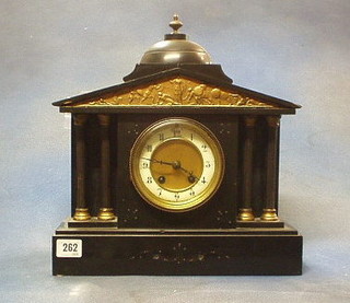 A French 19th Century 8 day striking mantel clock contained in a black marble architectural case