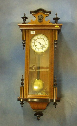 A 19th Century striking Vienna style regulator, the 6" circular dial with Roman numerals striking on a gong, contained in a walnutwood case