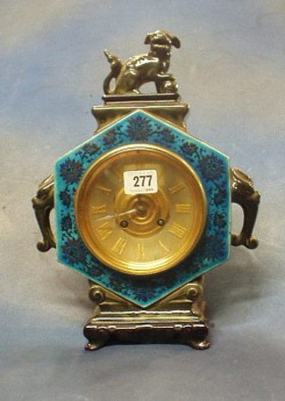 A 19th Century 8 day striking mantel clock with silvered dial and Roman numerals, contained in an Oriental style porcelain case surmounted by a seated figure of a Dog of Fo, the base marked Bruean