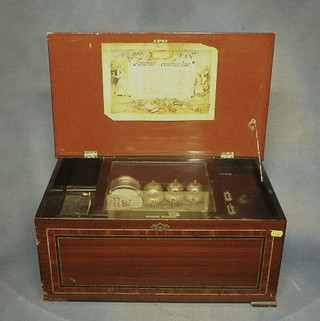 A 19th Century Swiss musical box, playing 10 airs, striking 6 bells and having 5 beaters to the drum, contained in an inlaid rosewood case 23"